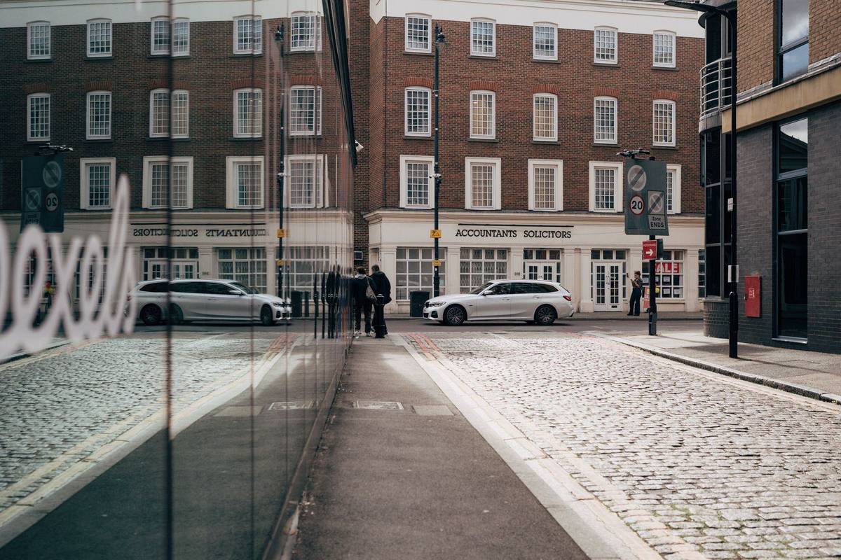 Black sedan outside glass office buildings in the European Quarter of Brussels