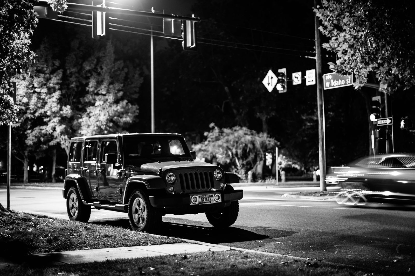 Black SUV waiting on an Uptown Charlotte street in the evening