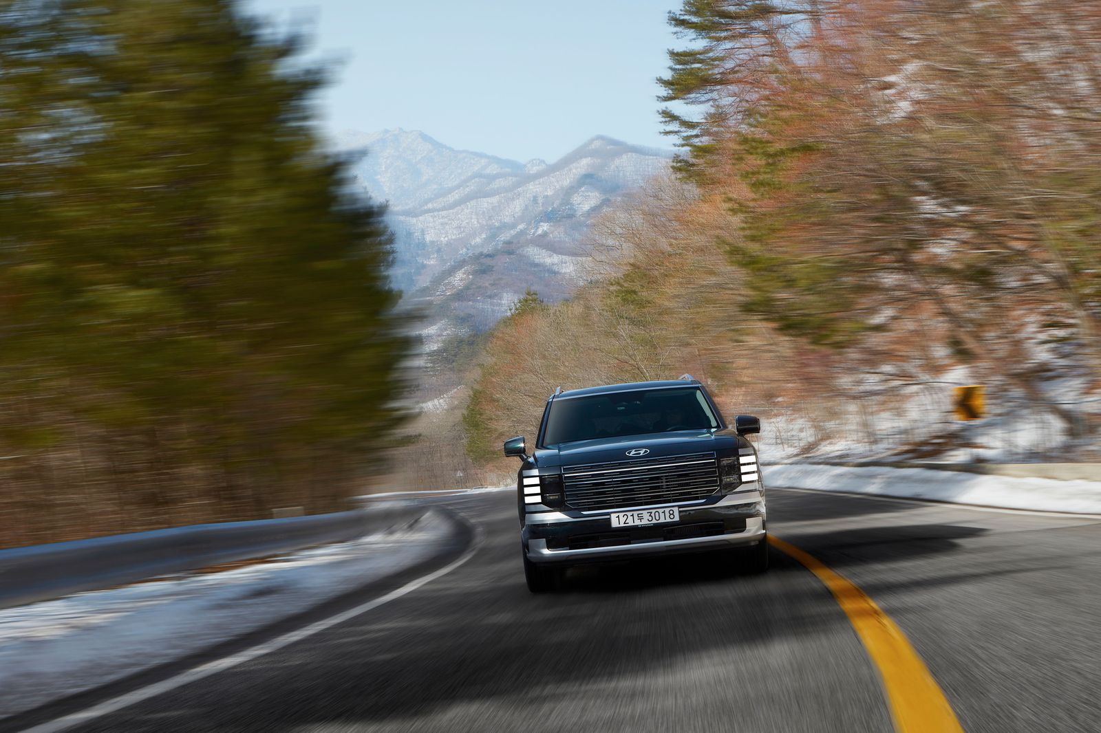 Black SUV on a snowy mountain highway west of Denver