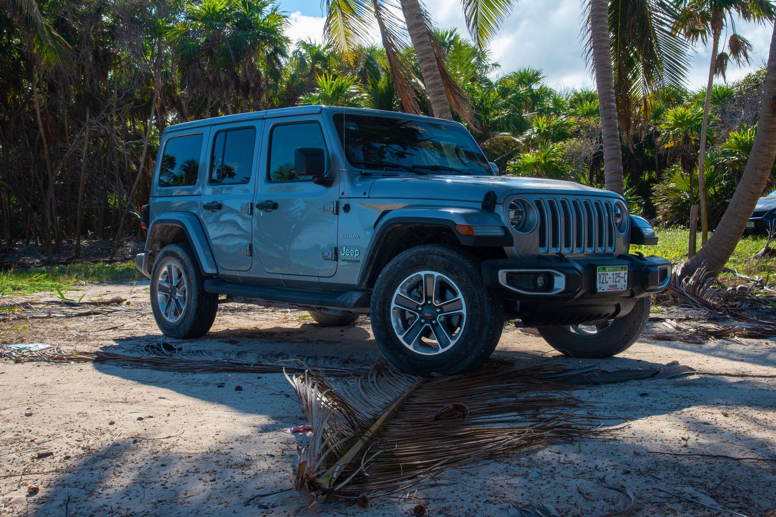 Black SUV on a palm-lined road near Fort Lauderdale beach