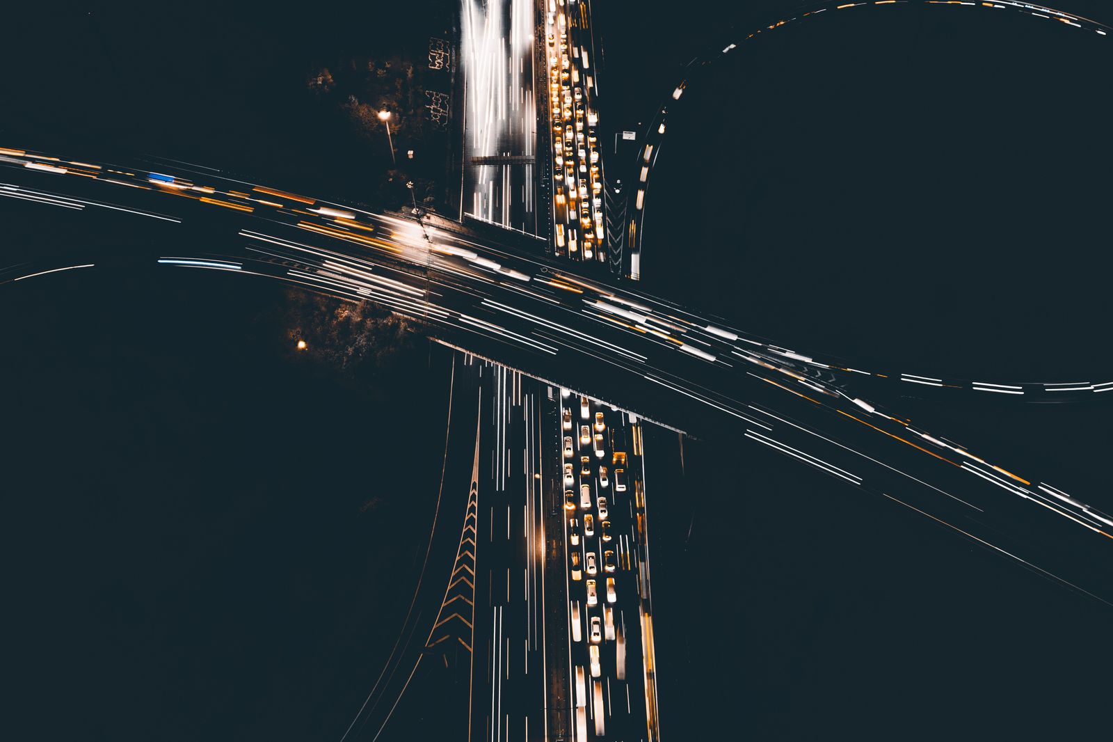 Black sedan on a Houston freeway interchange at night