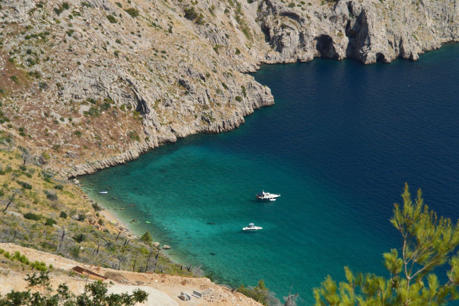 Superyacht at anchor in a turquoise Ibiza cove