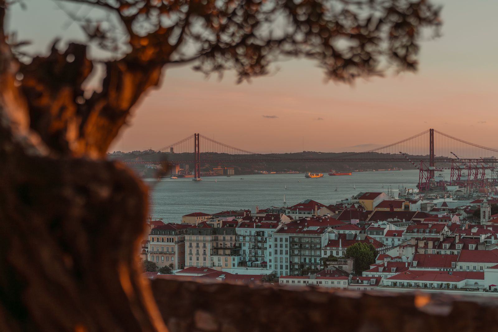 Traffic crossing a bridge over the Tagus in Lisbon at dusk