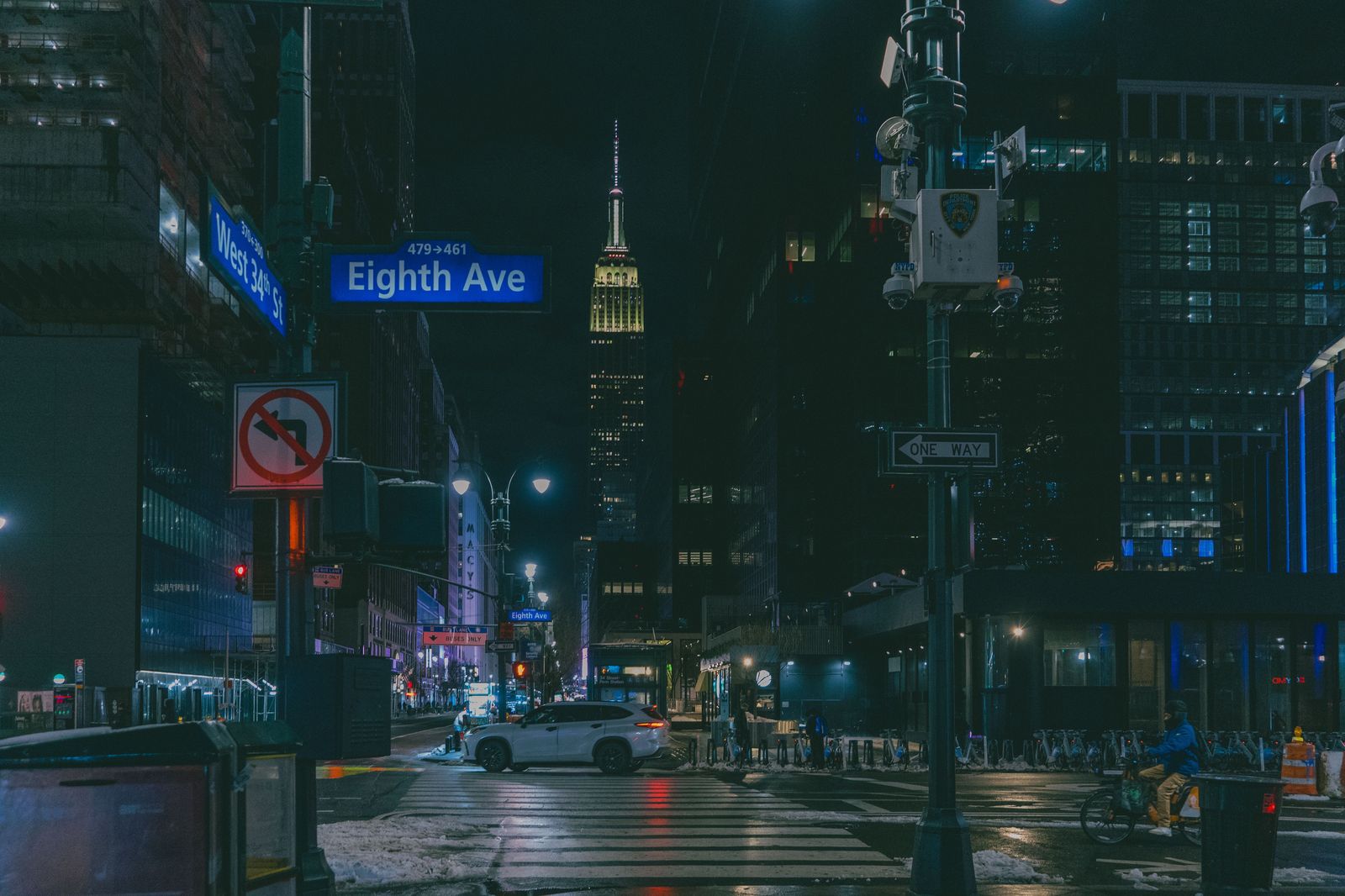 Black SUV waiting on a Manhattan avenue at night