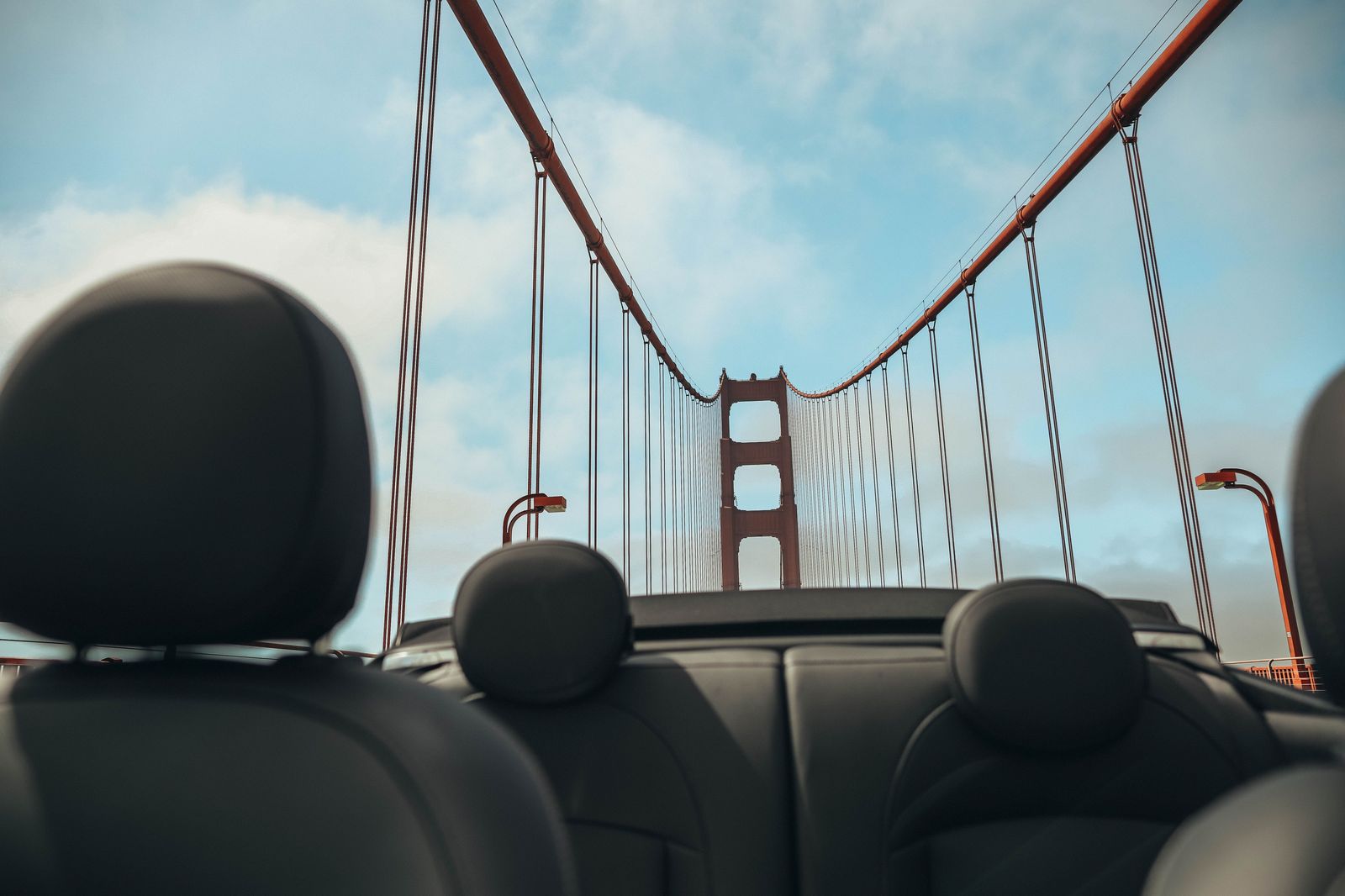 Black car approaching the Golden Gate Bridge