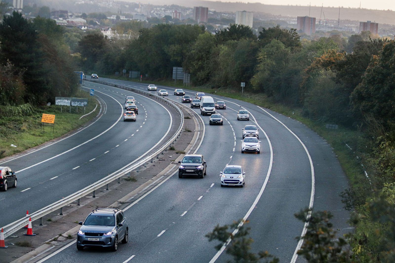 Black sedan on an English motorway at dusk heading for Southampton