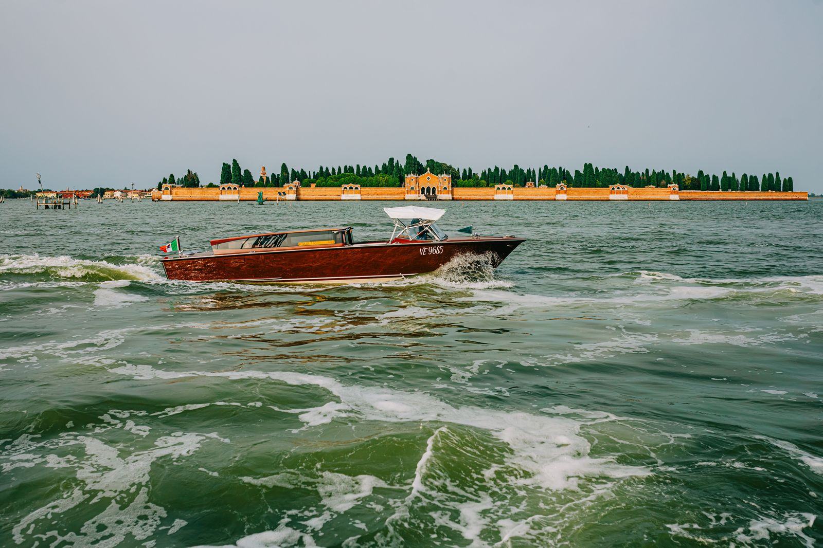 Wooden water taxi crossing the Venice lagoon