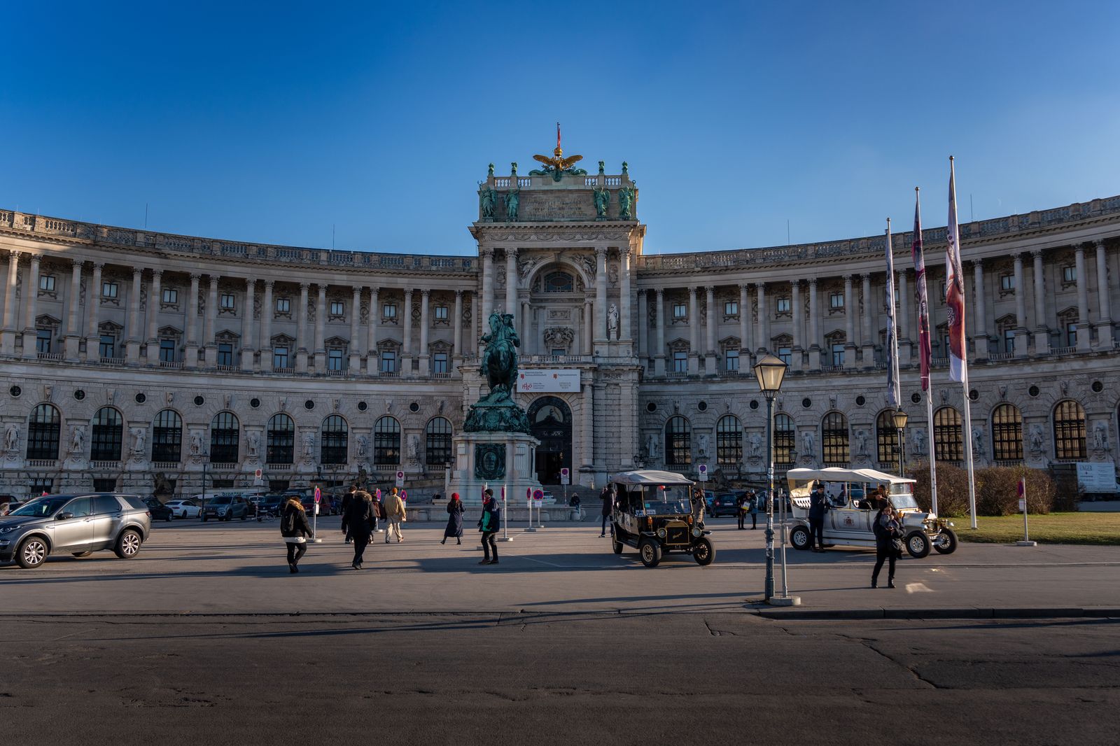 Black car on a Vienna street lined with imperial facades