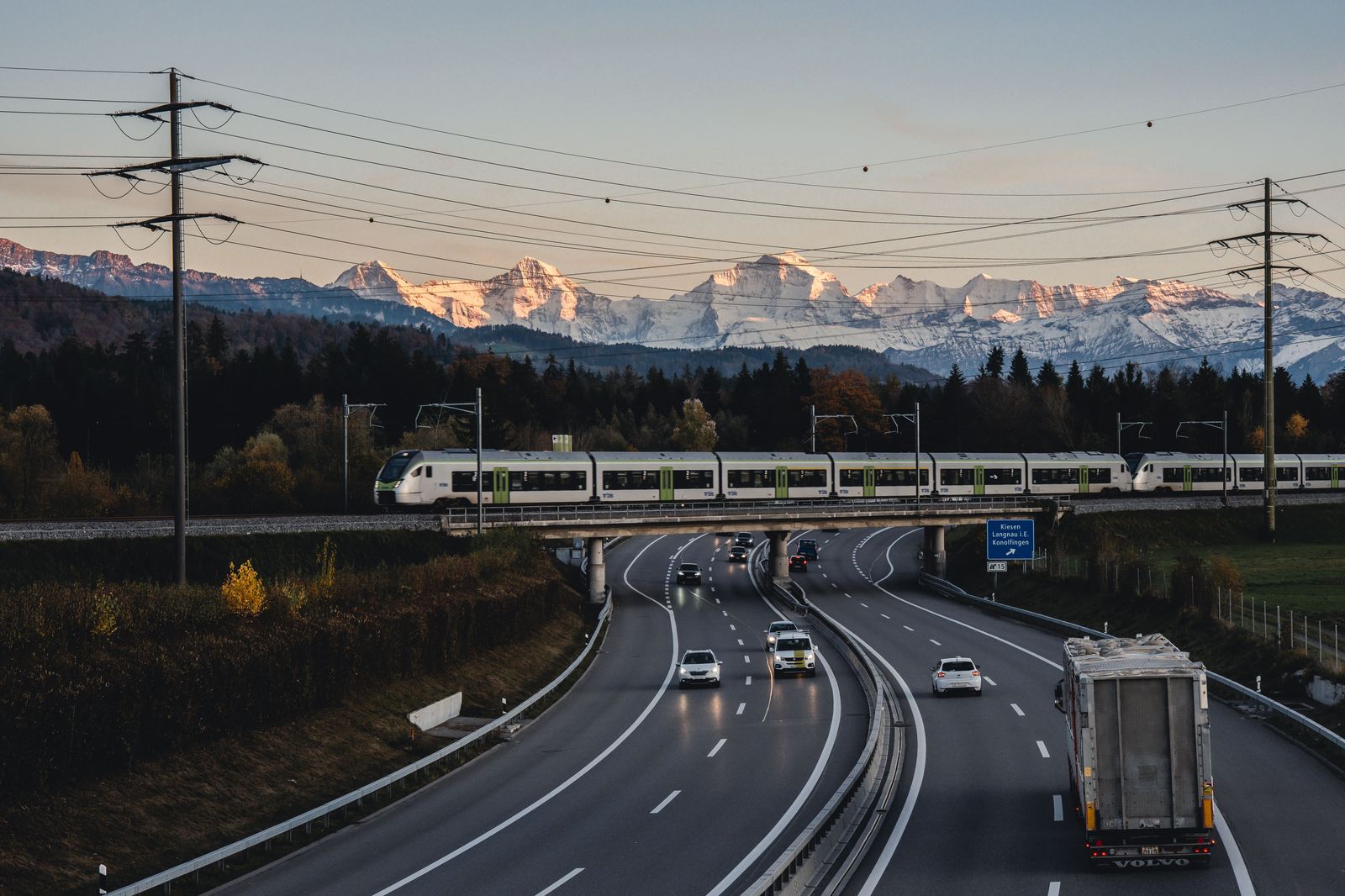 Car on a Swiss motorway with the Alps in the distance