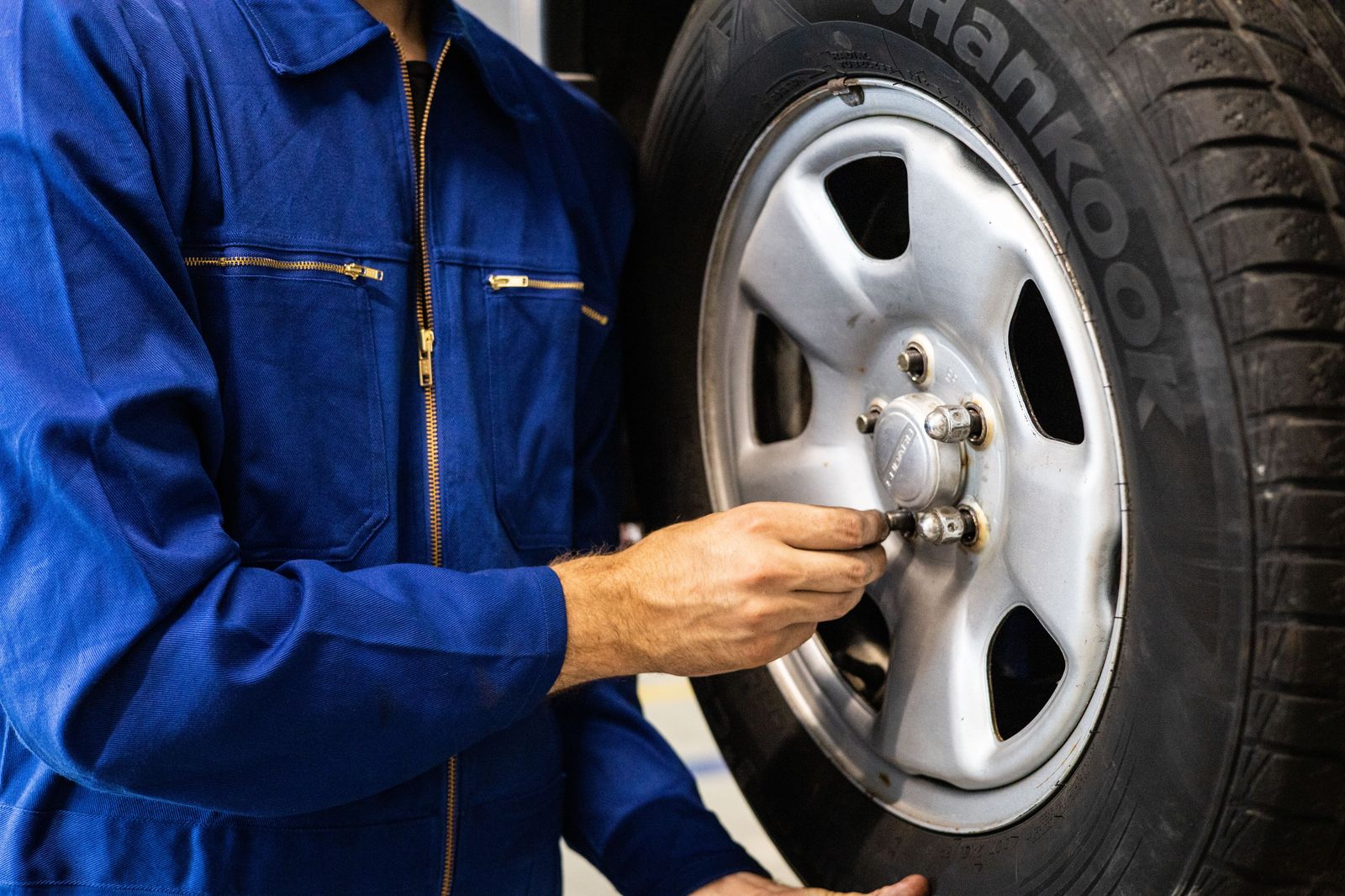 Technician inspecting a tyre on a chauffeur-driven sedan