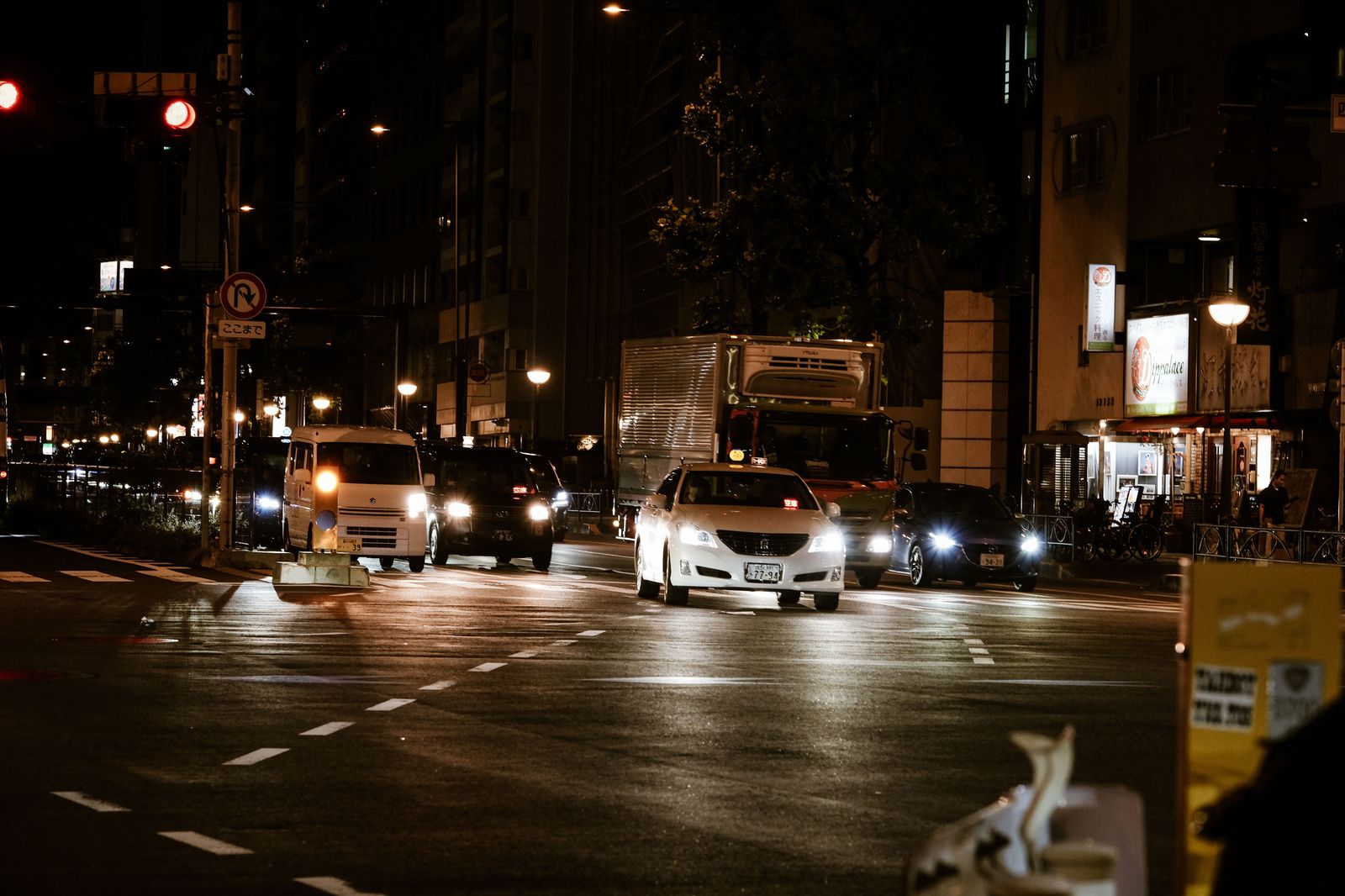 Crew van waiting at an airport commercial pickup zone at night