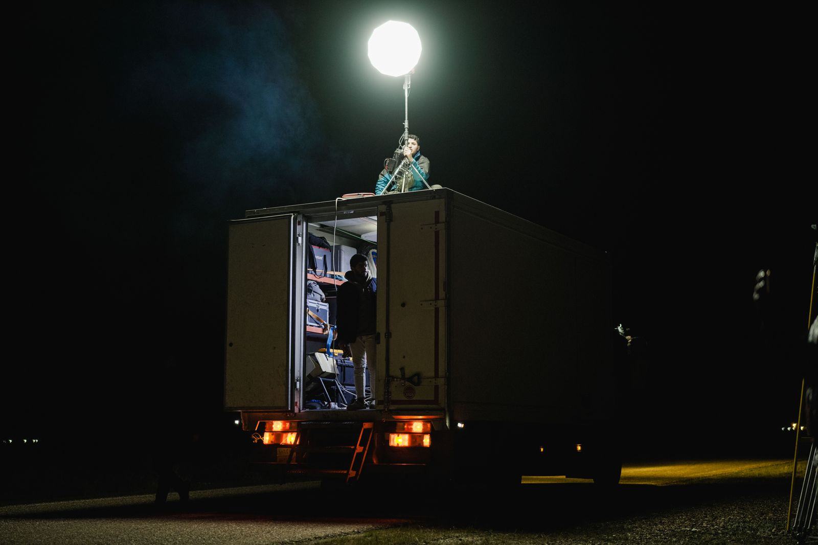 Production trailers and lights at a night film location