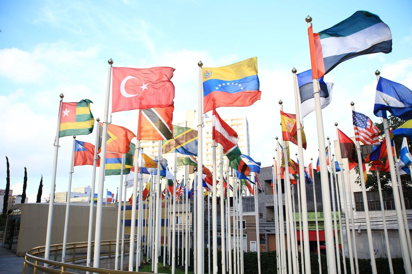 Flags outside a conference building entrance during an official meeting