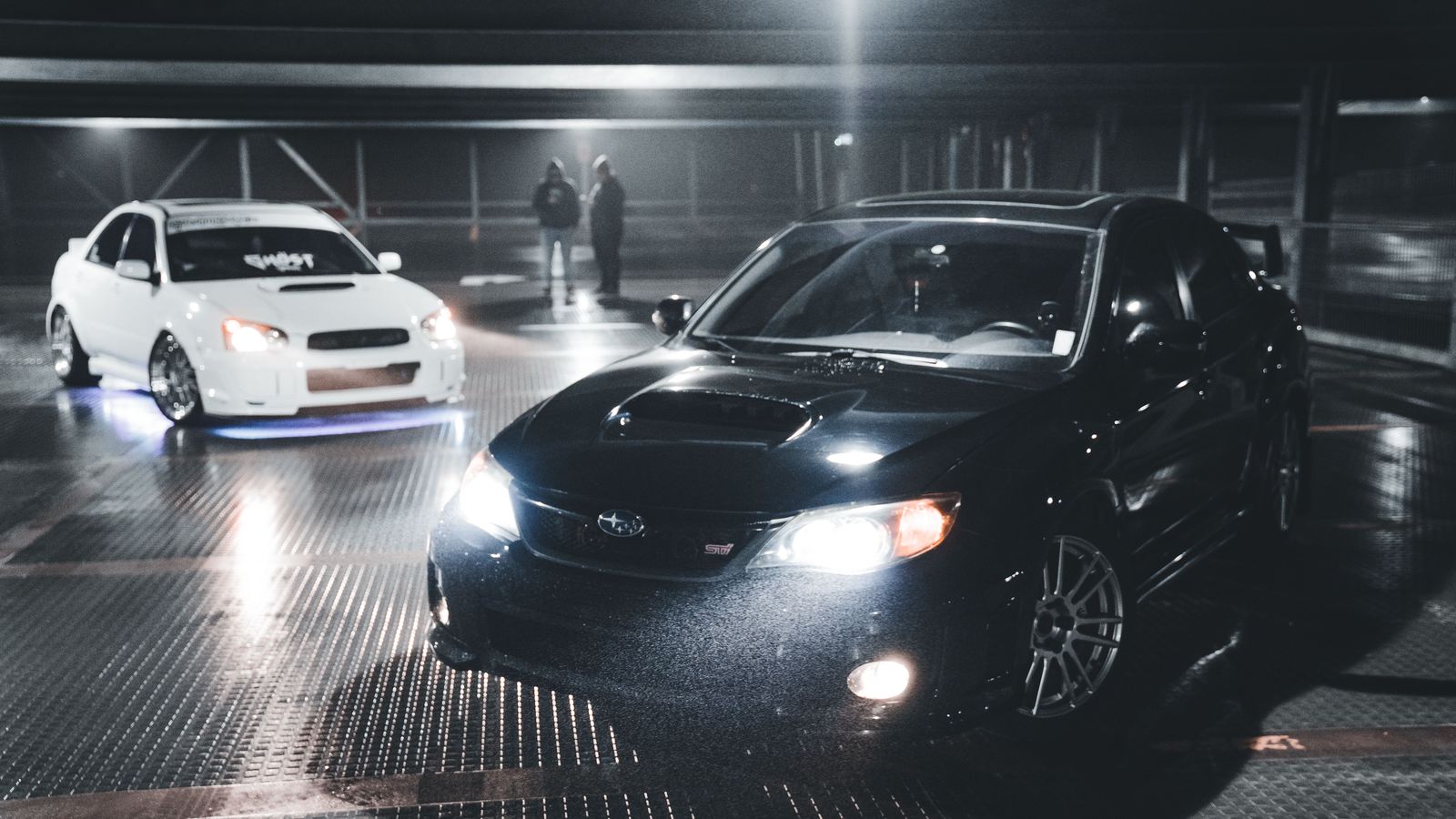 Black chauffeured sedan at night