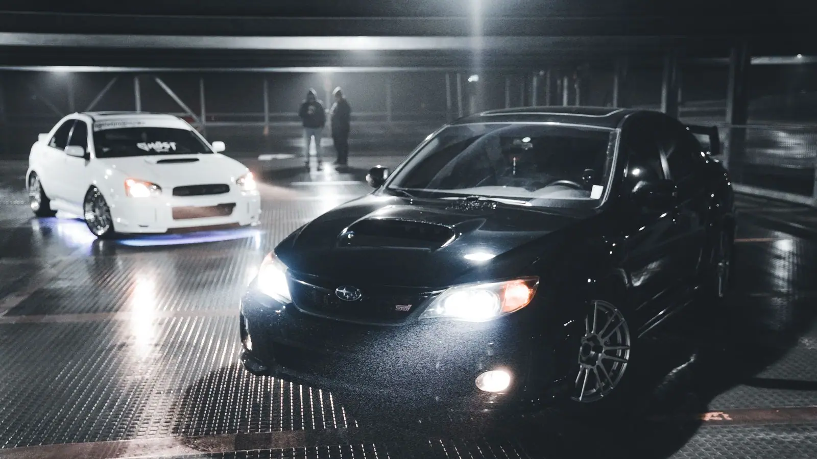 Black chauffeured sedan at night