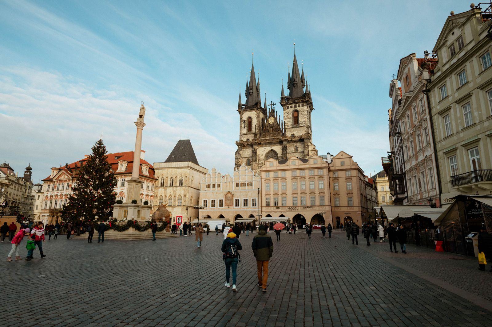 Travellers walking through an old town square during a private chauffeured day tour