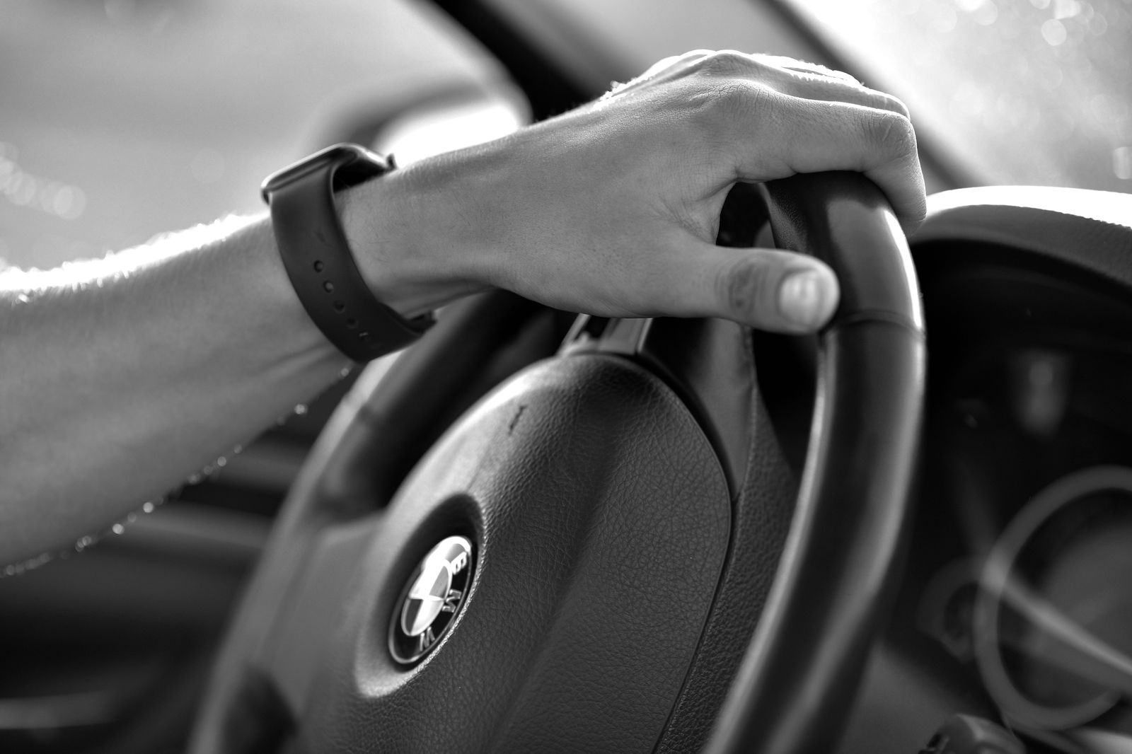 Watch on the wrist of a passenger in the back seat, the clock that an hourly chauffeur booking runs on