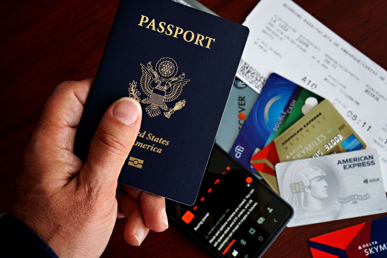 Business traveller with a passport at a boarding gate, the start of an international chauffeur itinerary