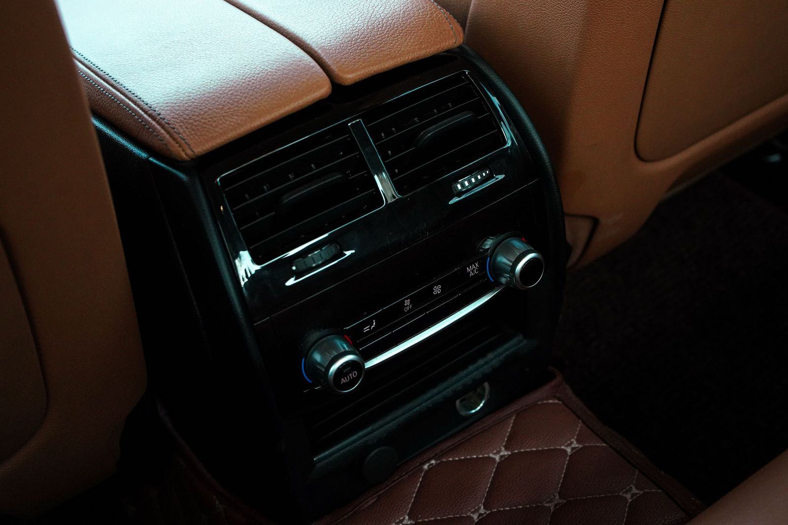 Leather rear seat of a luxury chauffeur car prepared for a passenger